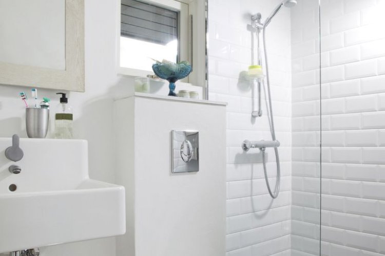 Installing a bathroom vent fan.